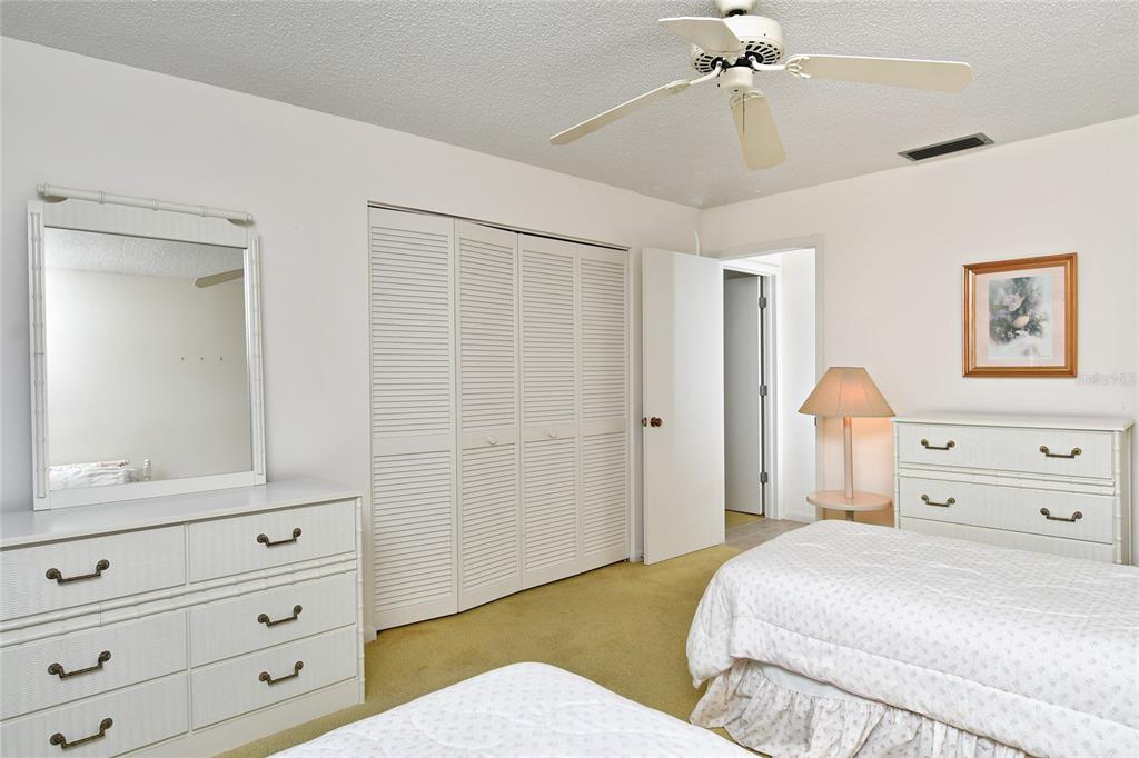 2001 Little Pine Circle, Unit 11B Punta Gorda, FL 33955 - Photo 25 of 45 a bedroom with a bed and a dresser