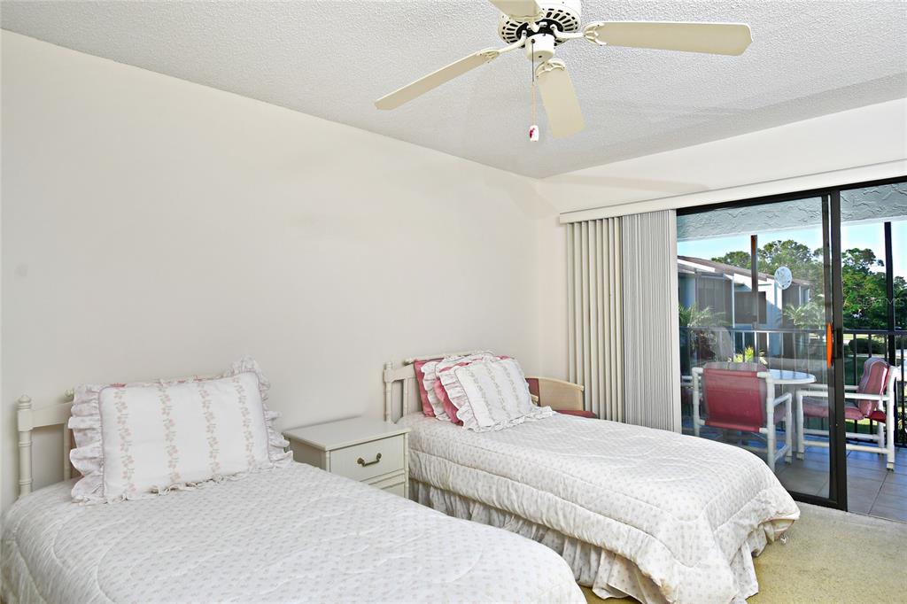 2001 Little Pine Circle, Unit 11B Punta Gorda, FL 33955 - Photo 26 of 45 a bedroom with a bed and a chandelier