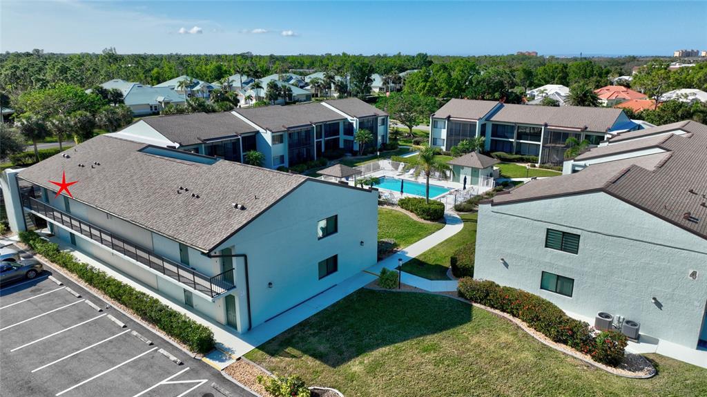 2001 Little Pine Circle, Unit 11B Punta Gorda, FL 33955 - Photo 35 of 45 an aerial view of a house with swimming pool and large trees