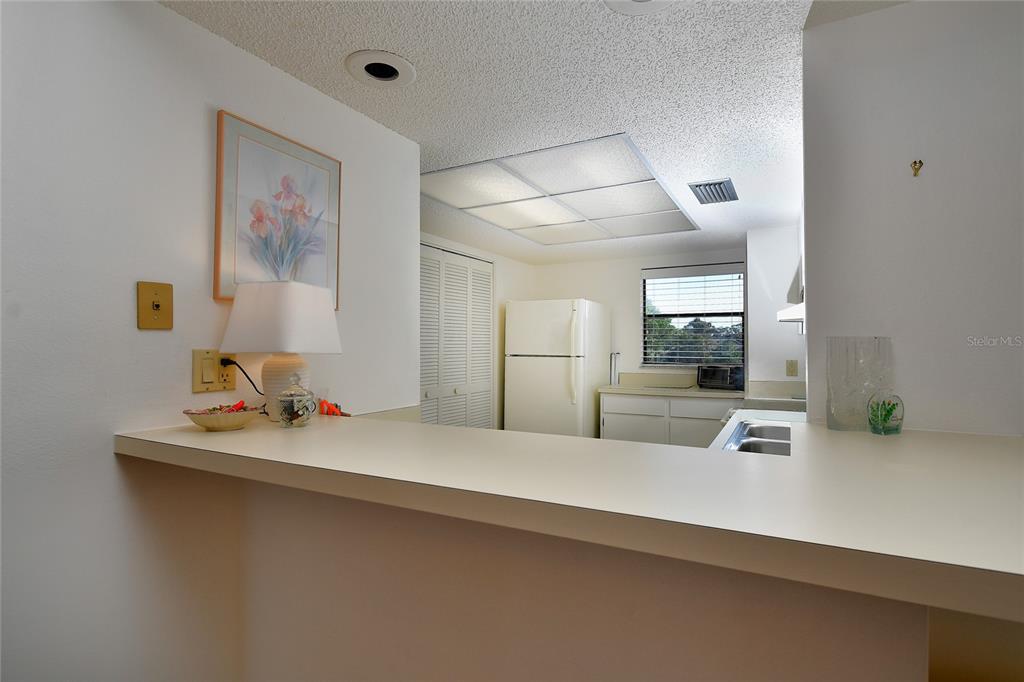 2001 Little Pine Circle, Unit 11B Punta Gorda, FL 33955 - Photo 5 of 45 a view of a hallway that has a bed and a desk in it