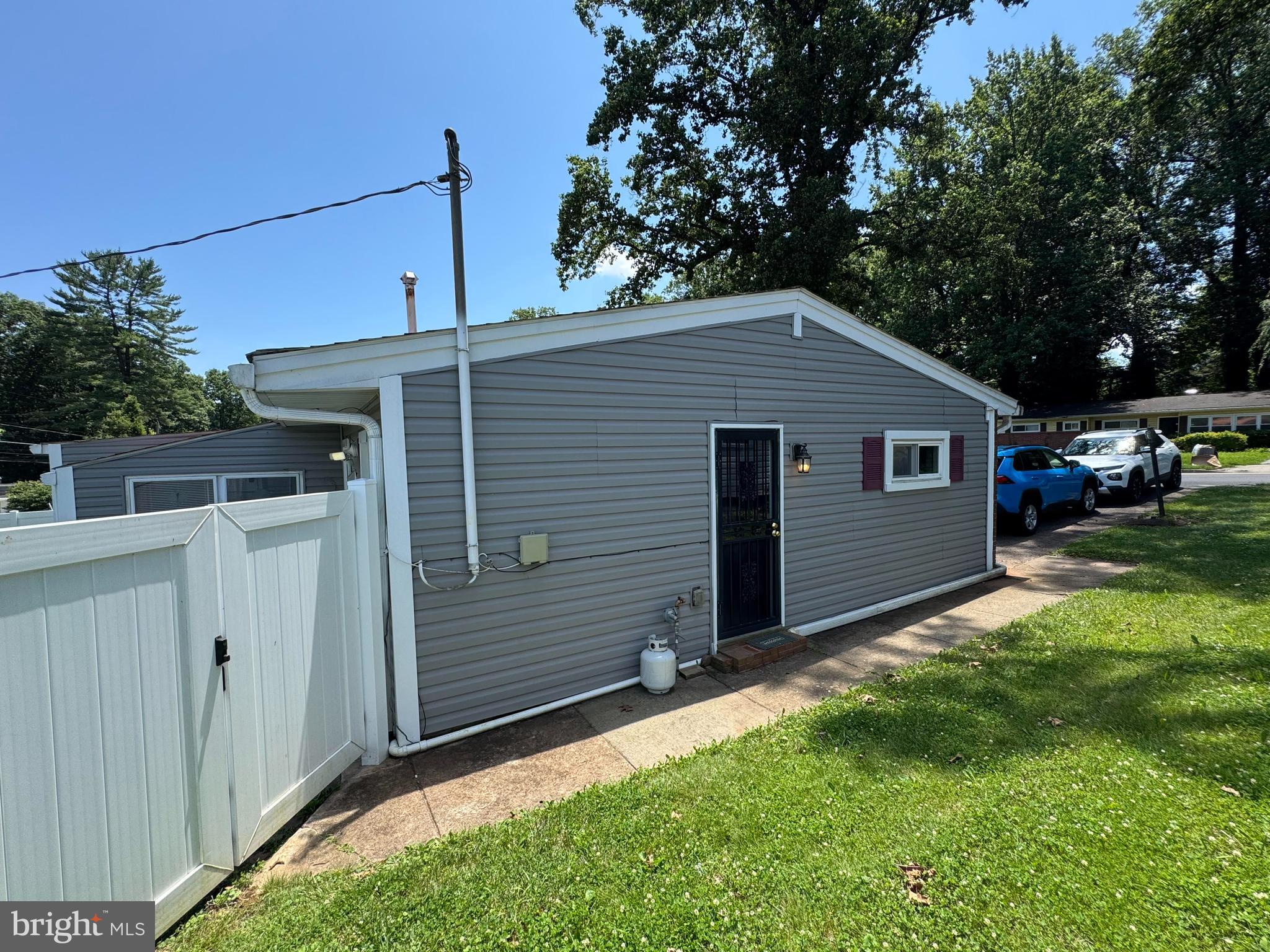 6703 Alter Street Baltimore, MD 21207 - Photo 3 of 12 a front view of a house with garden
