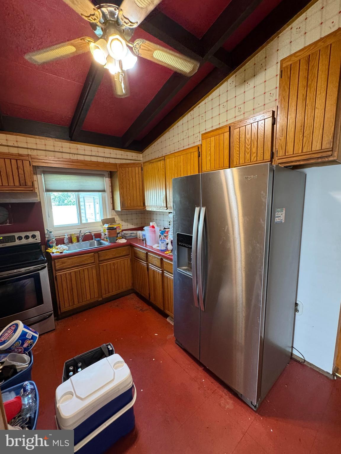6703 Alter Street Baltimore, MD 21207 - Photo 6 of 12 a kitchen with stainless steel appliances granite countertop a refrigerator a sink dishwasher stove and oven