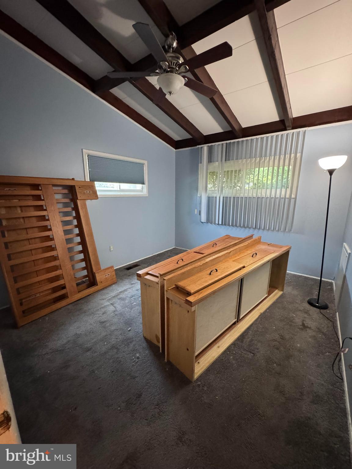 6703 Alter Street Baltimore, MD 21207 - Photo 10 of 12 a blue bed sitting in a room next to a window