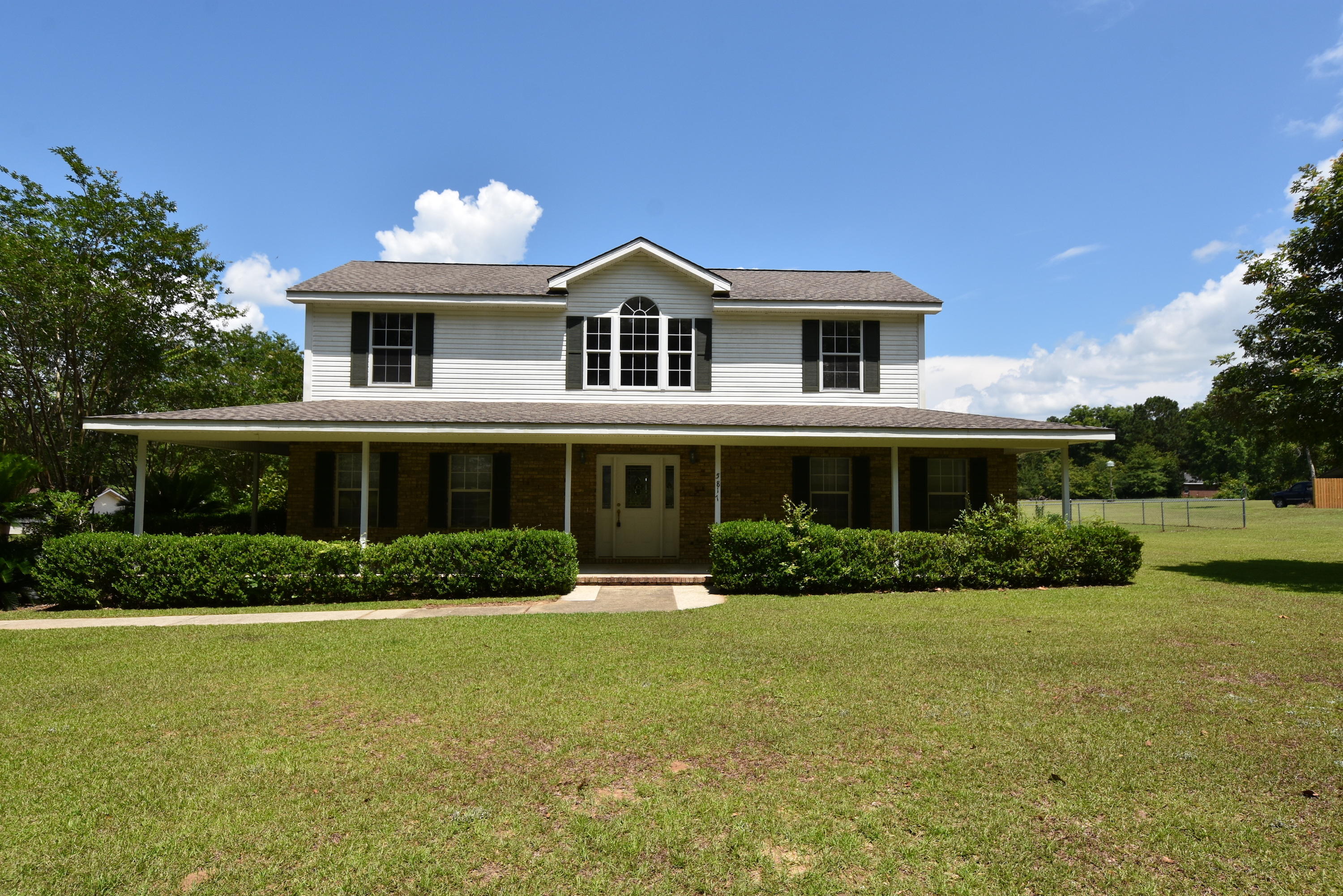 5817 Dairy Road Baker, FL 32531 - Photo 1 of 36 a front view of a house with a yard
