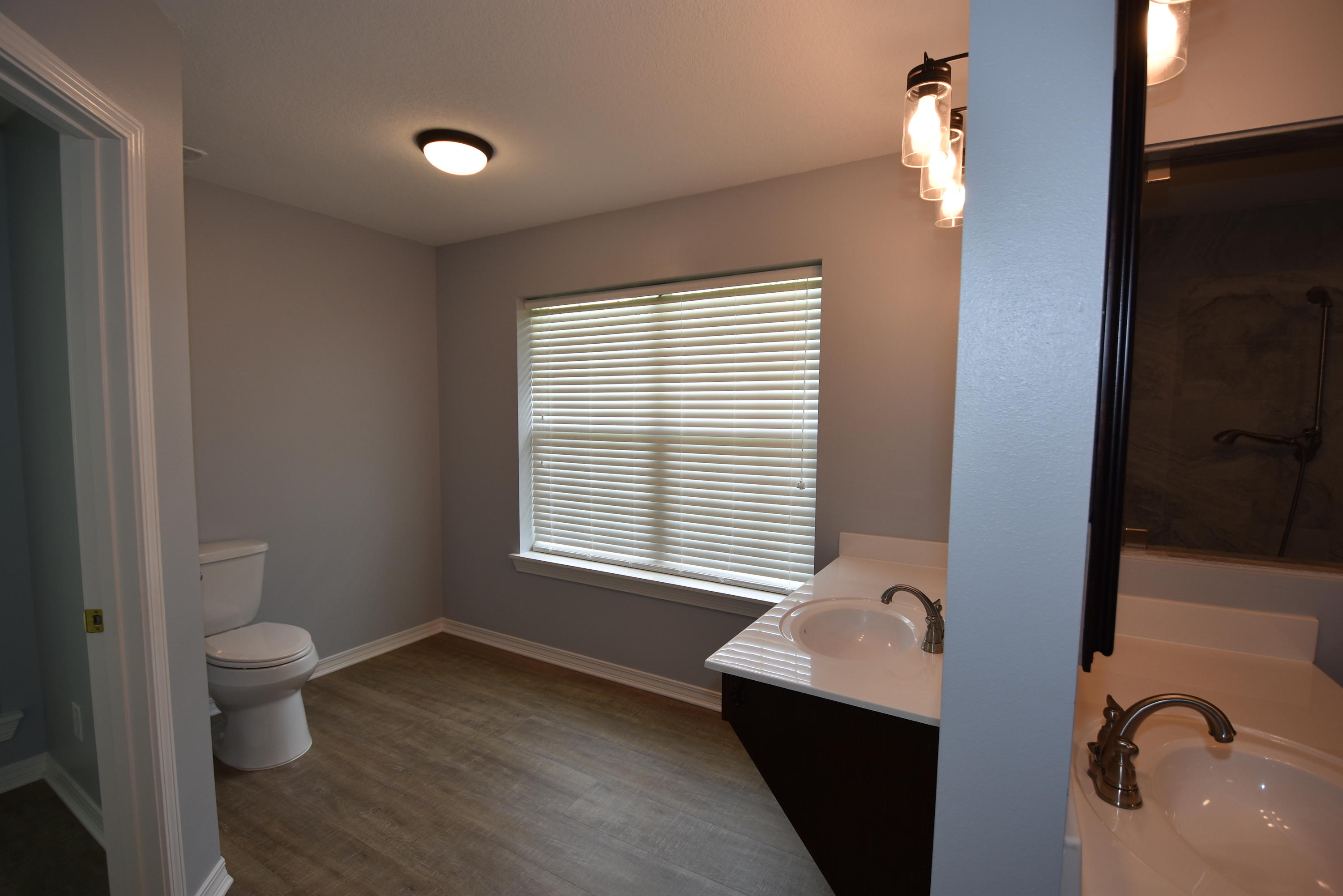 5817 Dairy Road Baker, FL 32531 - Photo 19 of 36 a bathroom with a toilet sink and mirror