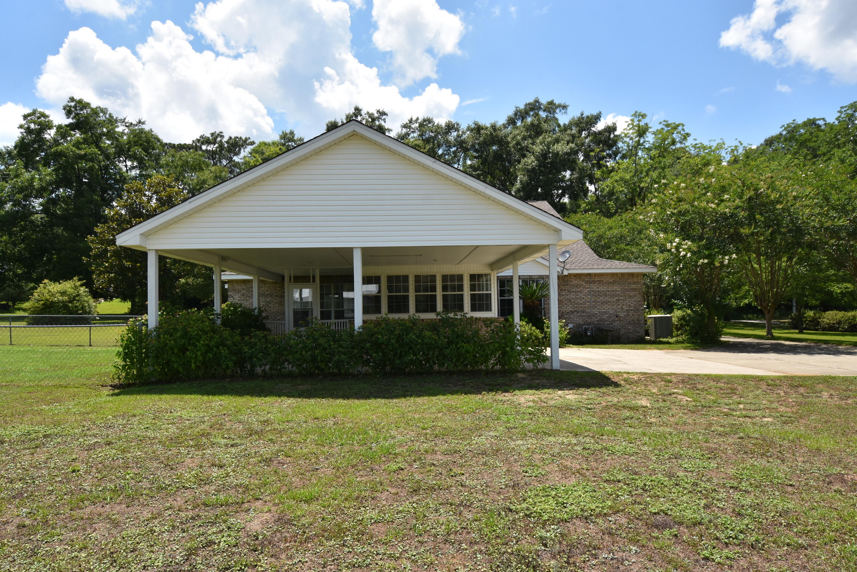 5817 Dairy Road Baker, FL 32531 - Photo 32 of 36 a front view of a house with a garden