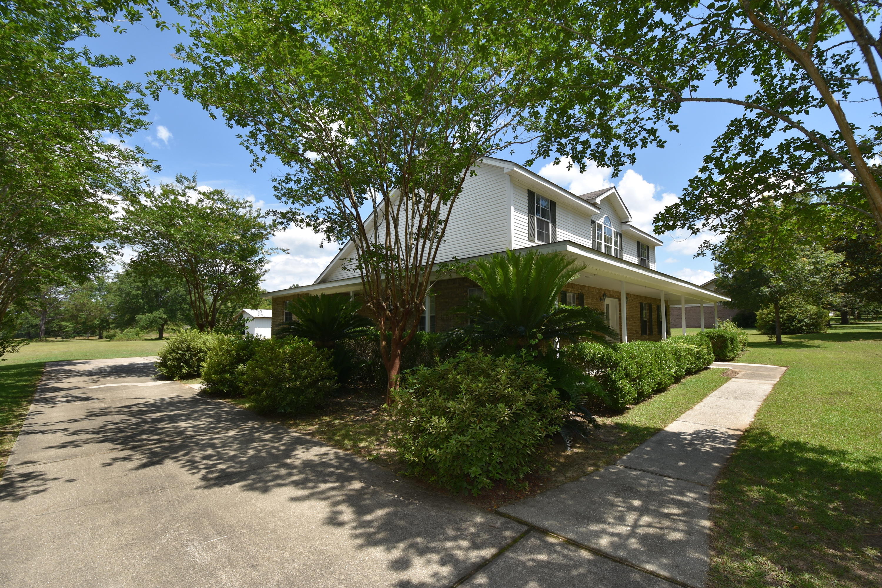 5817 Dairy Road Baker, FL 32531 - Photo 34 of 36 a front view of house with yard and trees