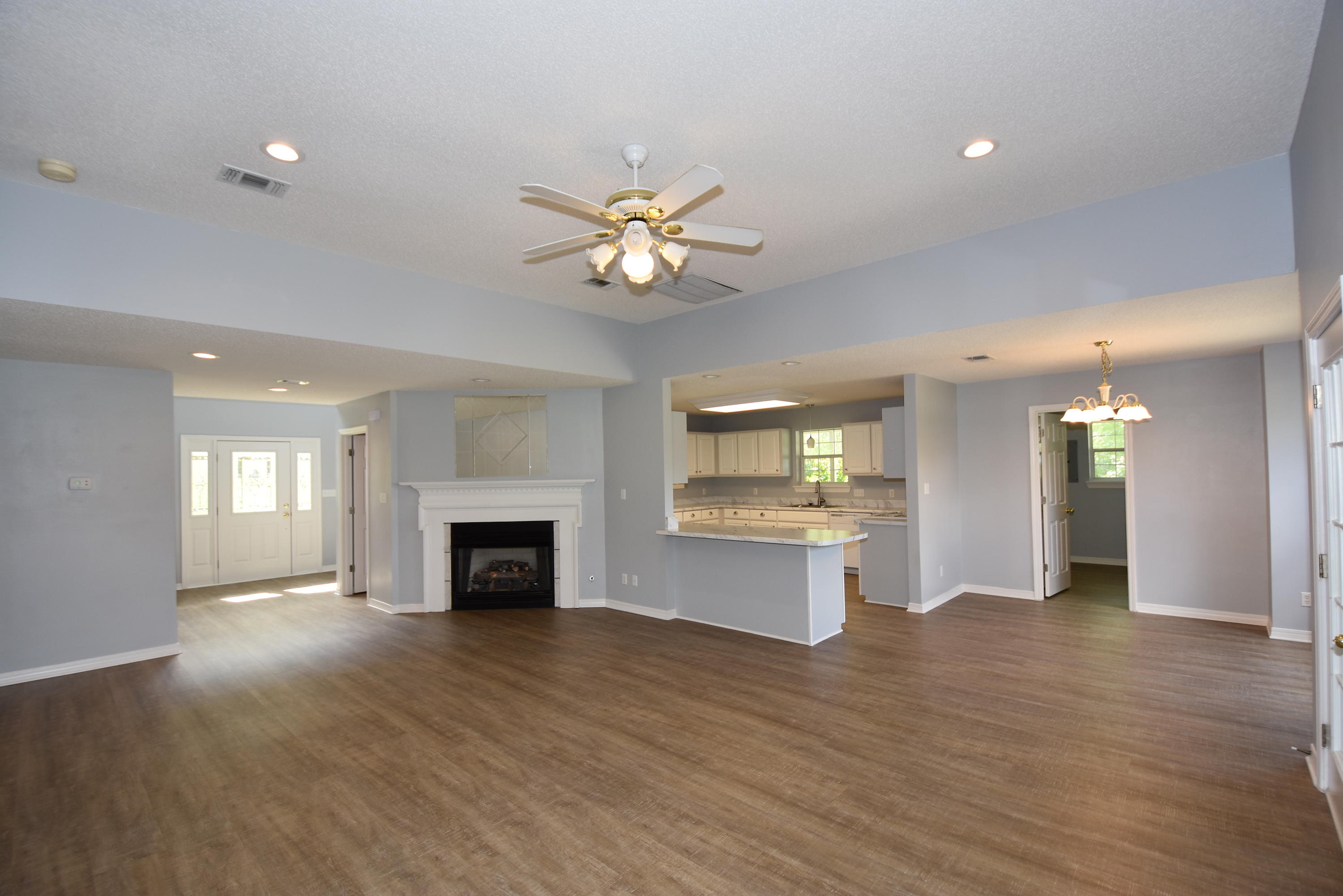 5817 Dairy Road Baker, FL 32531 - Photo 6 of 36 an empty room with a fireplace and fan