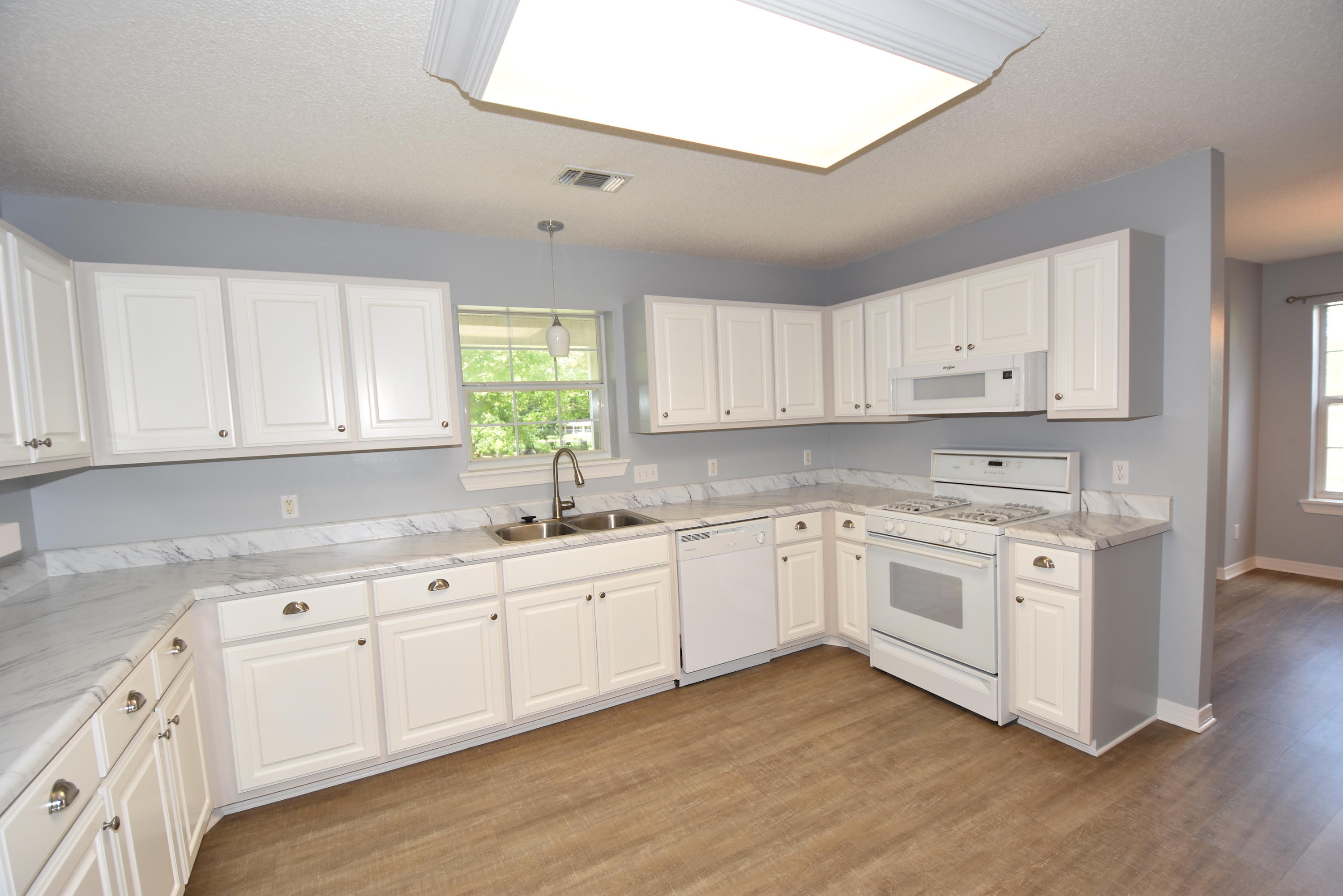 5817 Dairy Road Baker, FL 32531 - Photo 10 of 36 a kitchen with granite countertop white cabinets white stainless steel appliances and sink