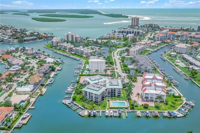 an aerial view of residential houses with outdoor space and lake view