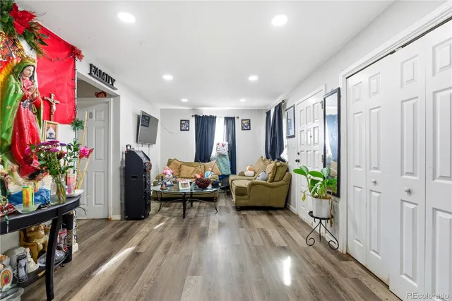 a living room with furniture and wooden floor