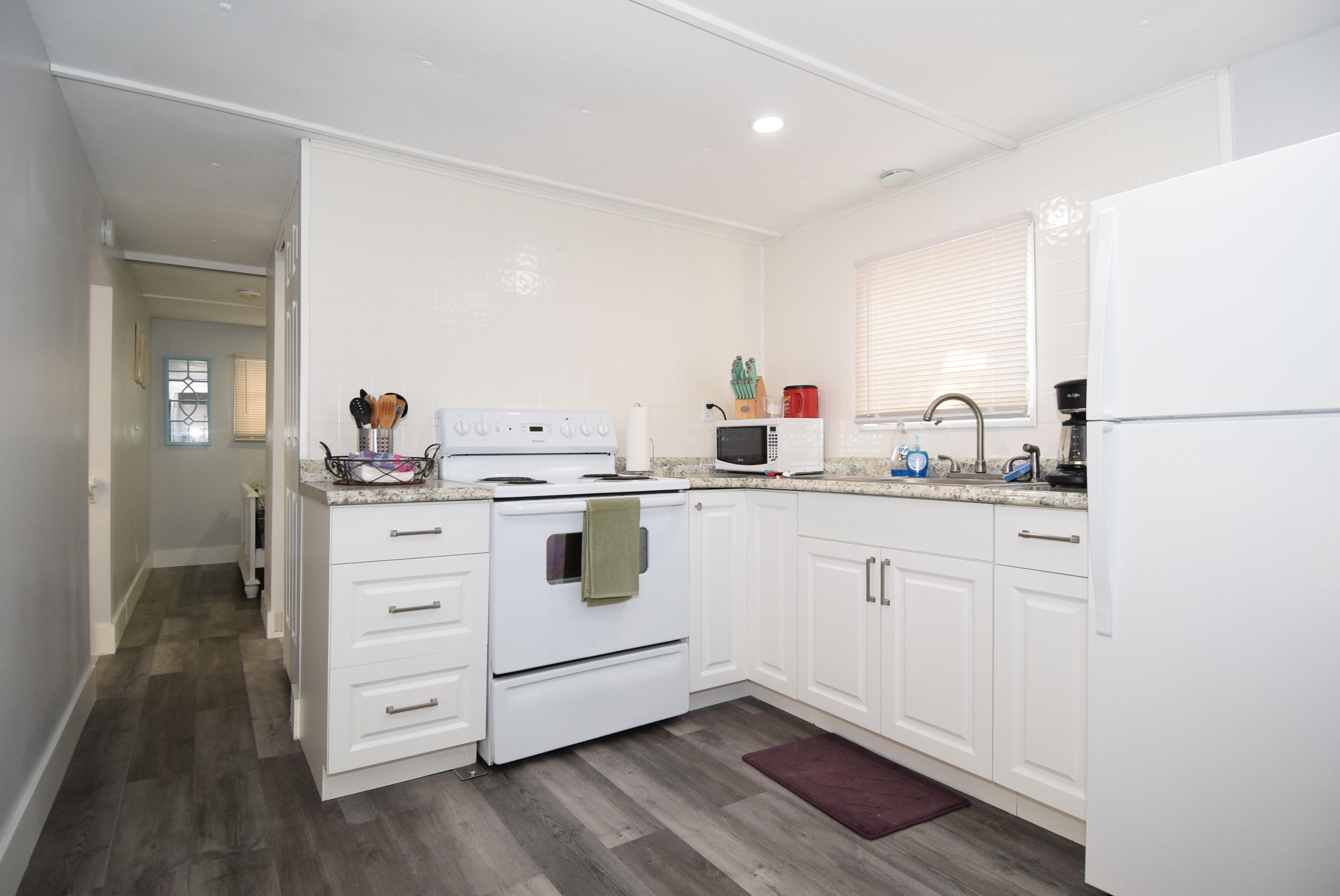 110 Tweedy Pie Terrace Key Largo, FL 33037 - Photo 2 of 21 a kitchen with white cabinets and white appliances