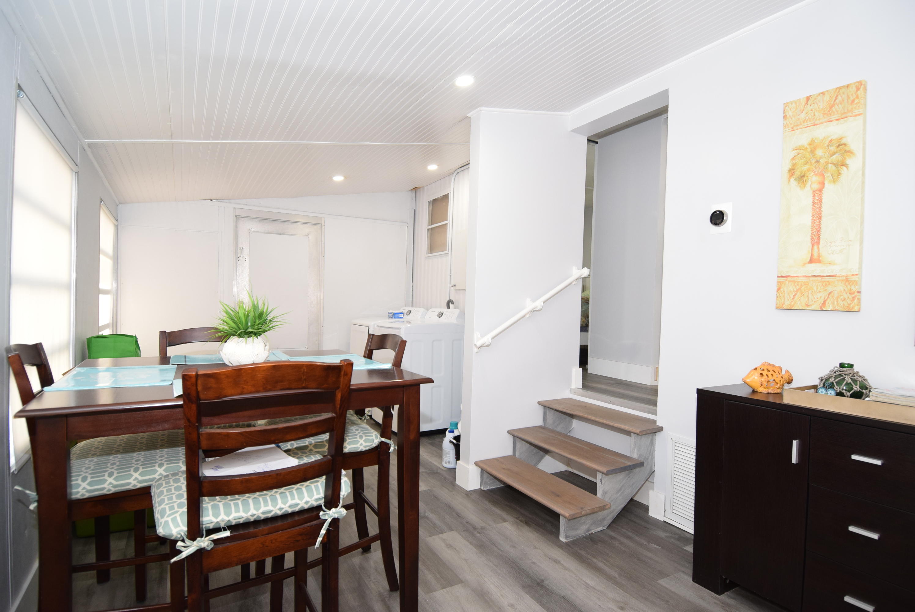 110 Tweedy Pie Terrace Key Largo, FL 33037 - Photo 5 of 21 a view of a dining room with furniture and wooden floor