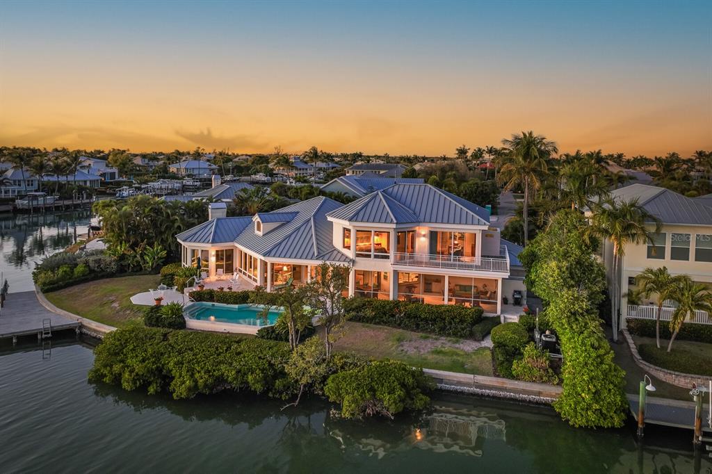 1601 Jean Lafitte Drive Boca Grande, FL 33921 - Photo 1 of 54 an aerial view of a house with garden space and lake view