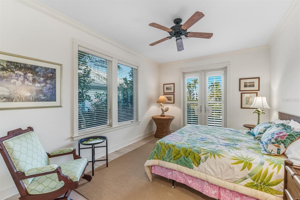 1601 Jean Lafitte Drive Boca Grande, FL 33921 - Photo 17 of 54 a bedroom with a bed a couch and a window