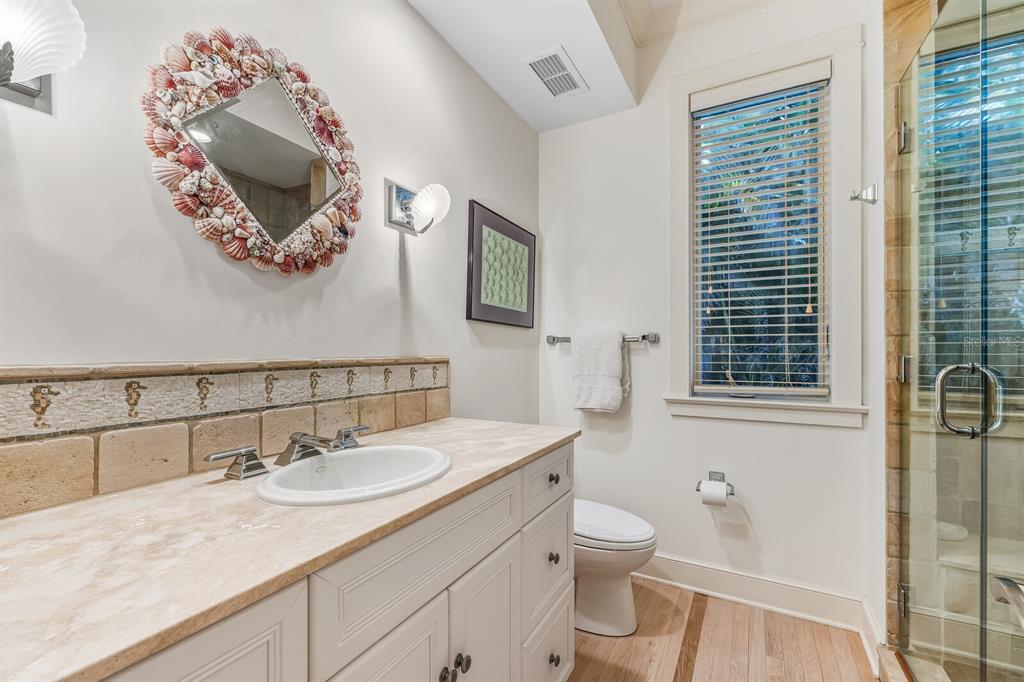 1601 Jean Lafitte Drive Boca Grande, FL 33921 - Photo 20 of 54 a bathroom with a toilet sink and mirror