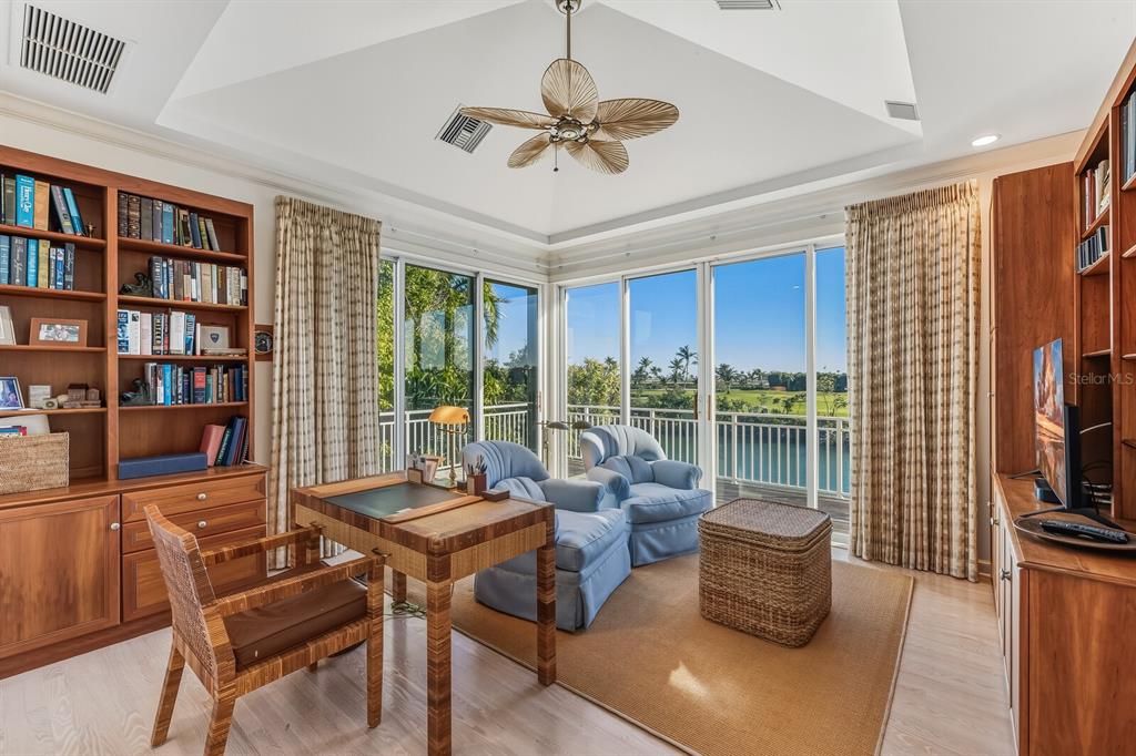 1601 Jean Lafitte Drive Boca Grande, FL 33921 - Photo 23 of 54 a living room with furniture a rug and a book shelf