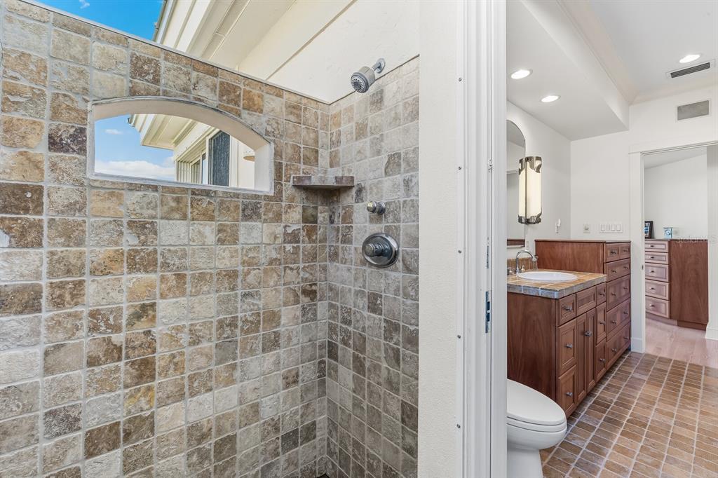 1601 Jean Lafitte Drive Boca Grande, FL 33921 - Photo 28 of 54 a bathroom with a granite countertop bathtub sink mirror vanity and toilet