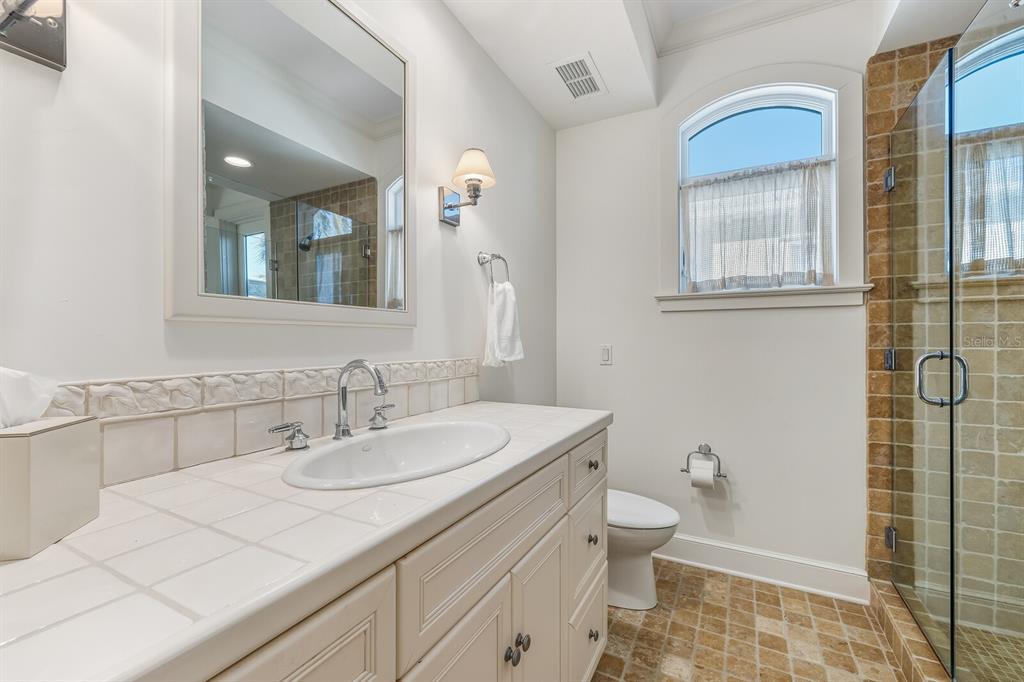1601 Jean Lafitte Drive Boca Grande, FL 33921 - Photo 30 of 54 a bathroom with a sink a toilet and a mirror