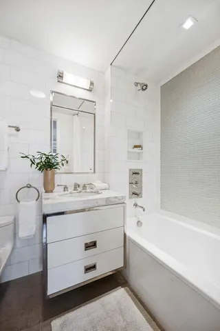 a spacious bedroom with a bed and glass window