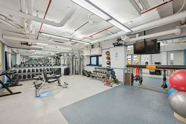 a view of a patio with couple chairs and potted plants