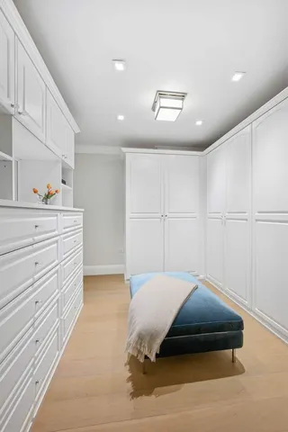 a spacious bedroom with a bed and a potted plant