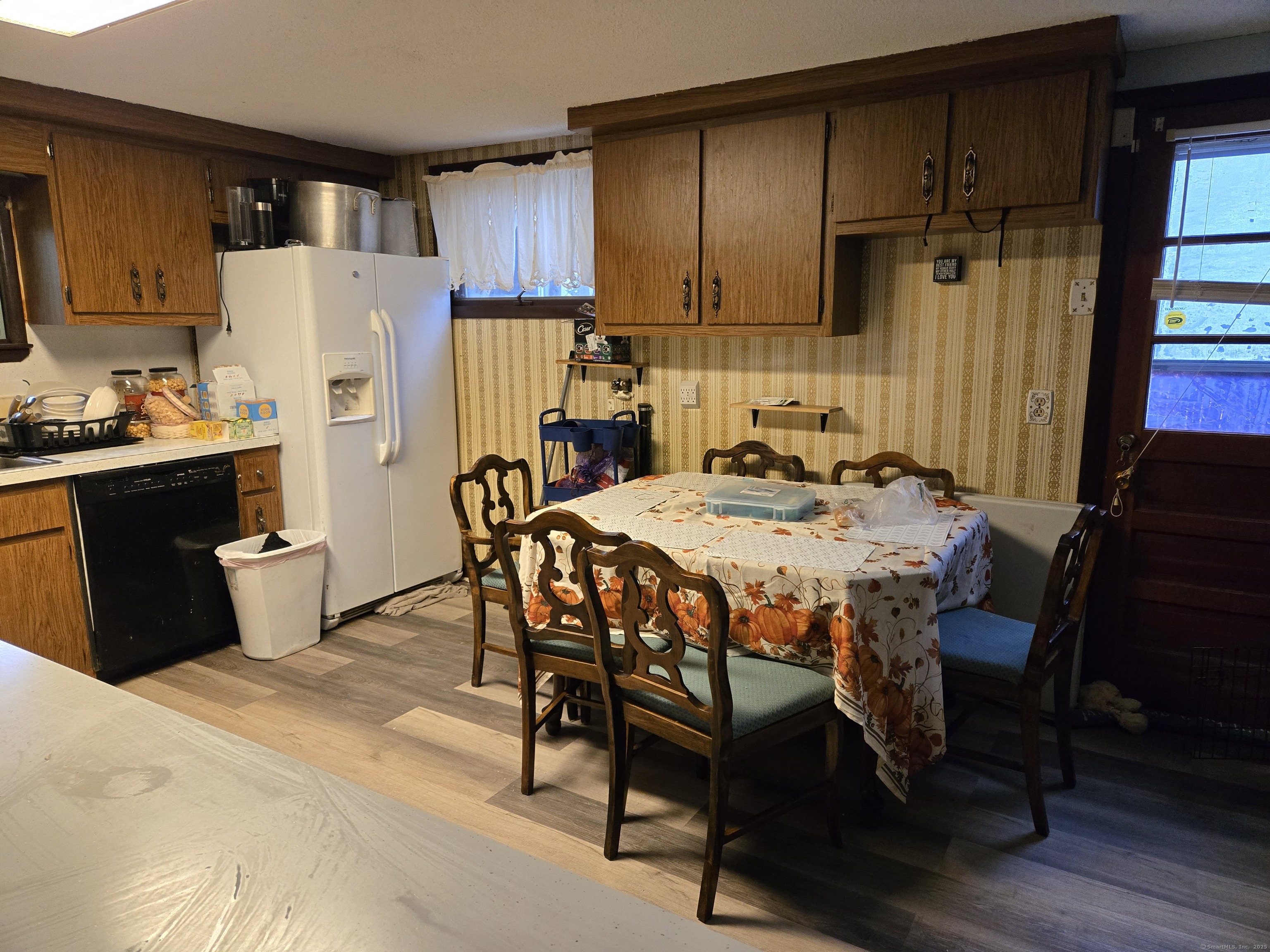 102 East Road Bristol, CT 06010 - Photo 9 of 15 a kitchen with a table chairs refrigerator and cabinets