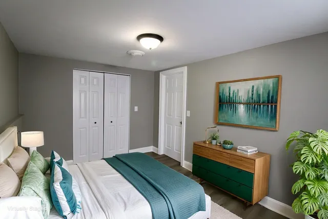 a bedroom with a bed and a potted plant