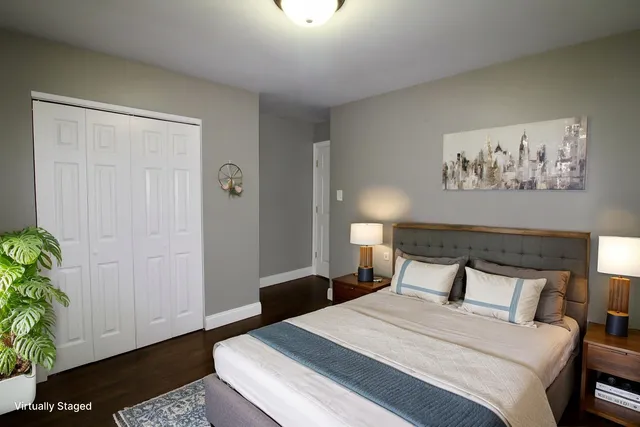 a bedroom with a bed and a potted plant