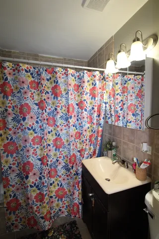a bathroom with a sink mirror and vanity