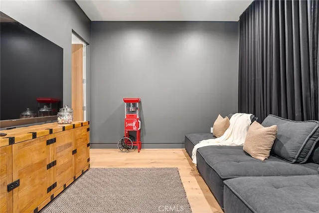 a bedroom with a bed and a flat tv screen on dresser