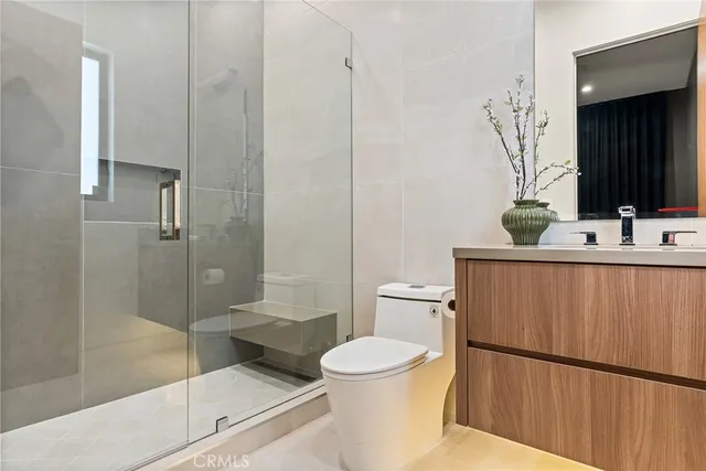 a bathroom with a toilet a sink and shower