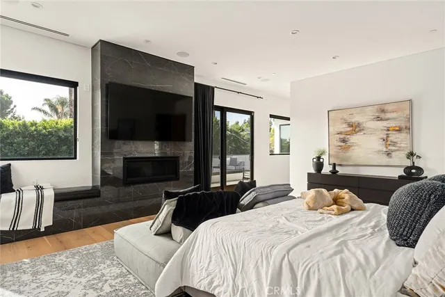 a bedroom with a large bed and a flat screen tv