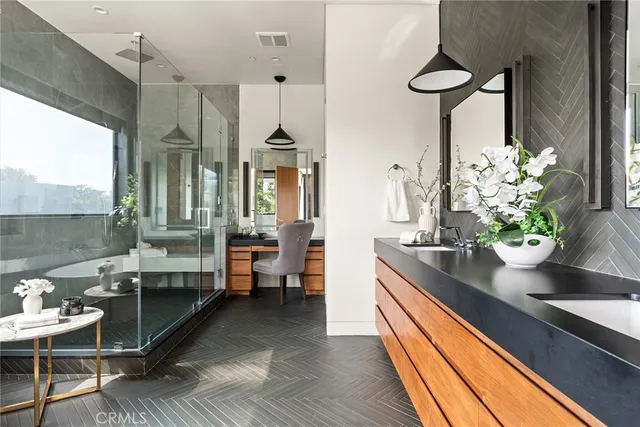 a white bath tub sitting in a bathroom next to a window