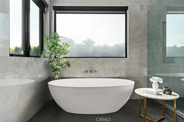 a bathroom with a granite countertop sink and a large mirror