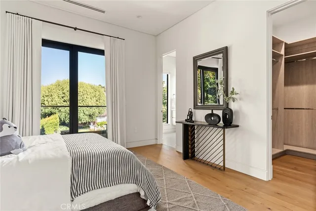 a spacious bedroom with a bed and a window