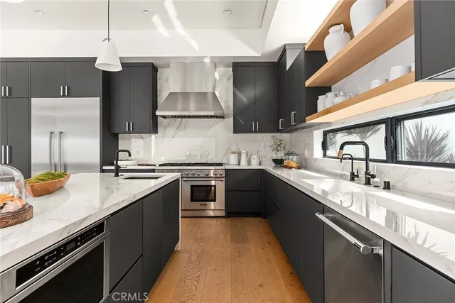 a open kitchen with stainless steel appliances granite countertop a sink stove and refrigerator