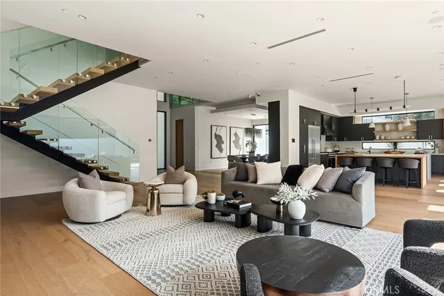 a living room with furniture and a view of kitchen