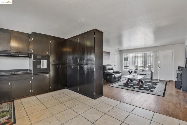 a view of a room with wooden floor and a window