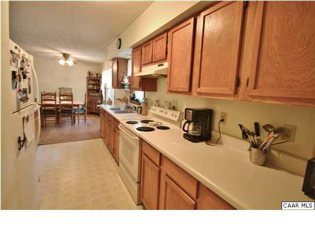 545 Chapel Road Ruckersville, VA 22968 - Photo 11 of 23 a kitchen with stainless steel appliances granite countertop a sink counter space and cabinets