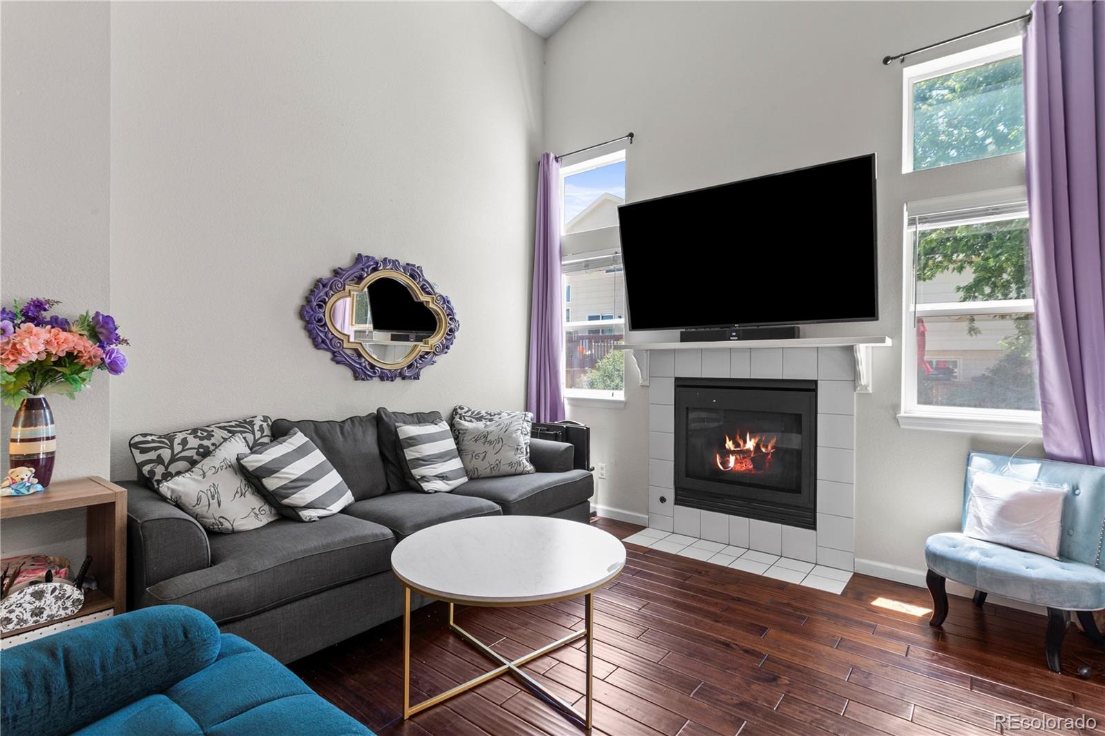 2212 Hyacinth Road Littleton, CO 80129 - Photo 8 of 44 a living room with furniture a flat screen tv and a fireplace