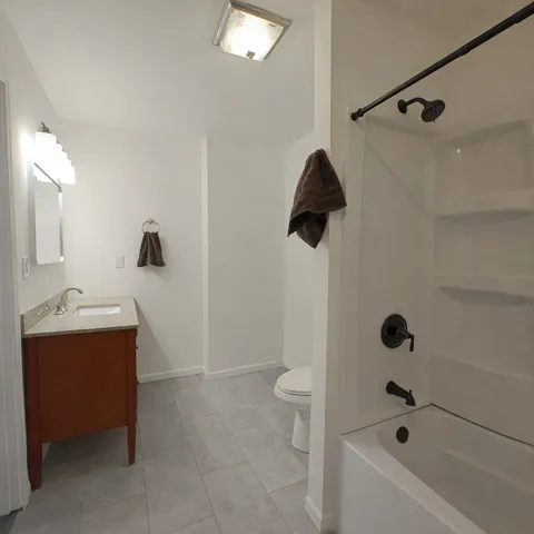 a bathroom with a sink a toilet and bathtub