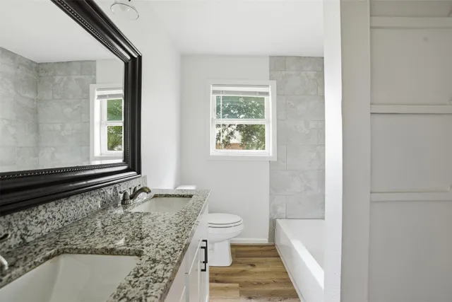a bathroom with a bathtub and window