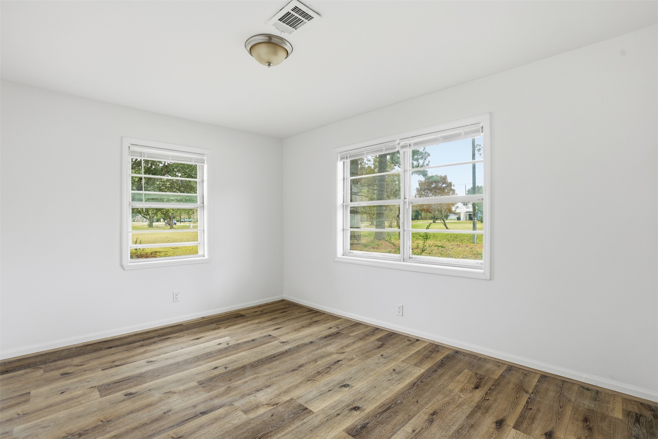 2751 Piper Road Pearland, TX 77581 - Photo 18 of 24 a view of an empty room with wooden floor and a window