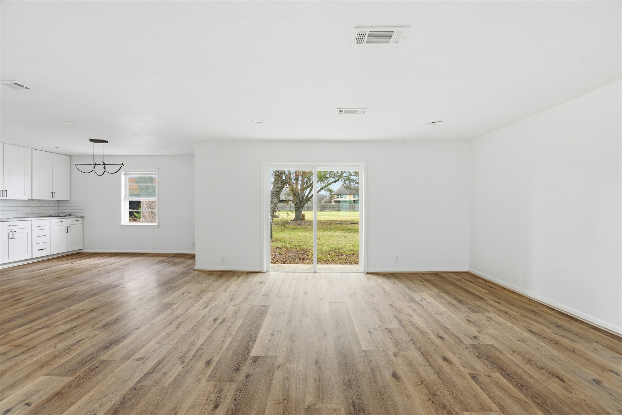 2751 Piper Road Pearland, TX 77581 - Photo 20 of 24 an empty room with wooden floor and windows
