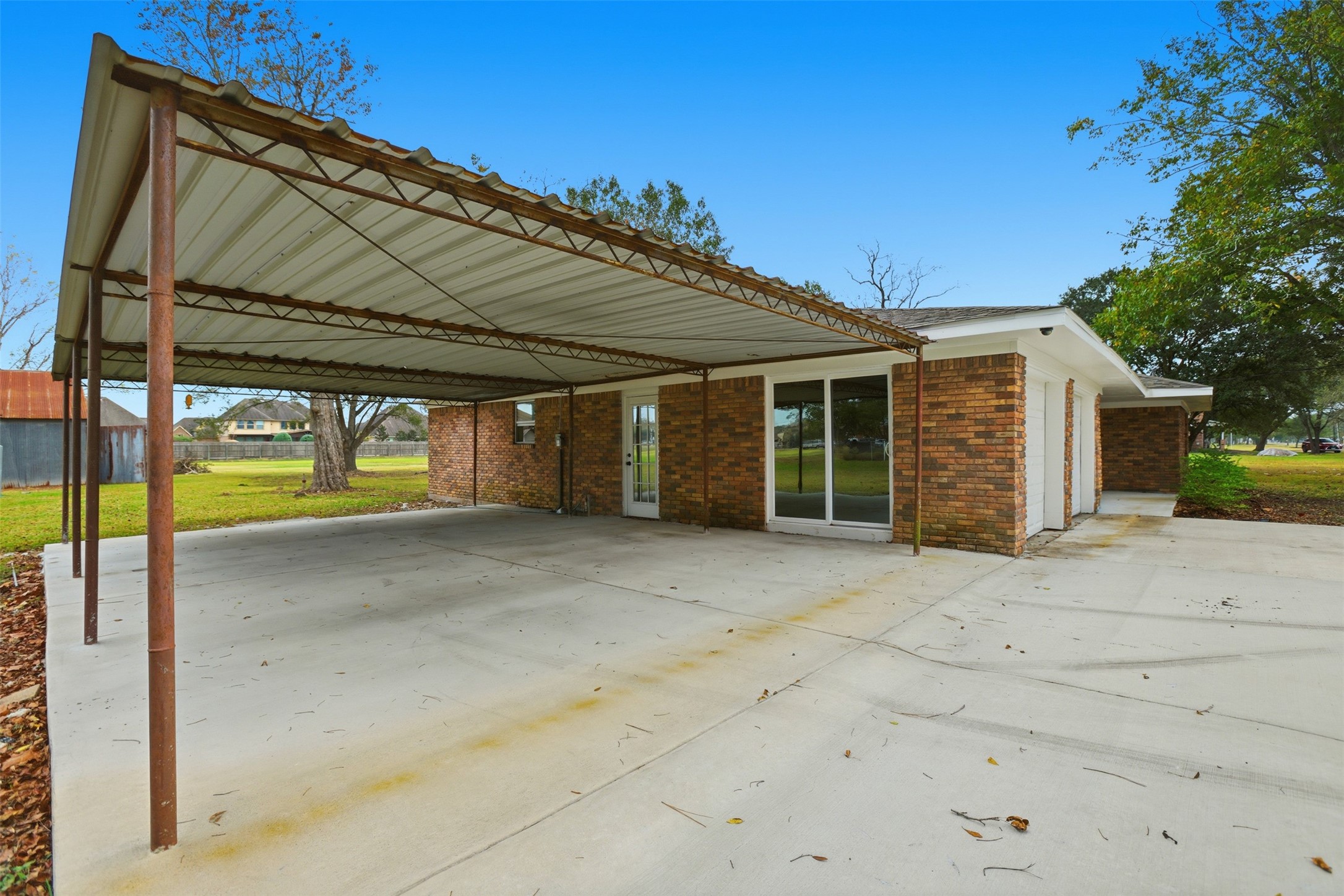 2751 Piper Road Pearland, TX 77581 - Photo 21 of 24 a view of a house with a backyard and a patio
