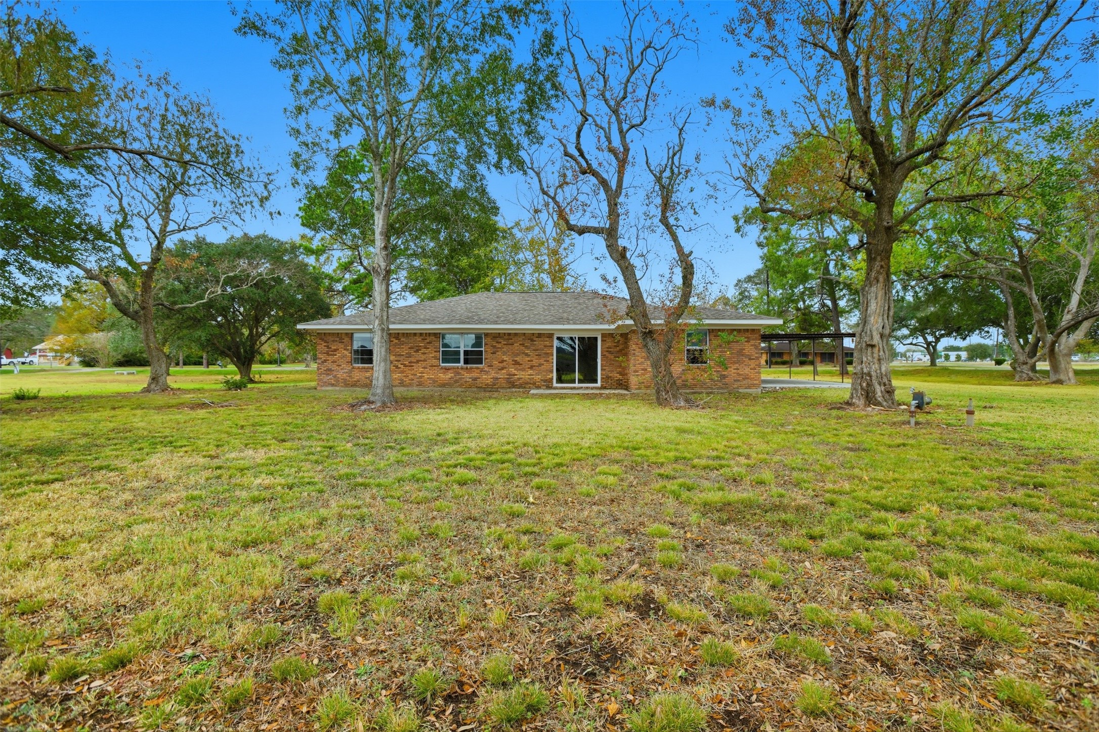 2751 Piper Road Pearland, TX 77581 - Photo 23 of 24 a front view of a house with a garden and trees