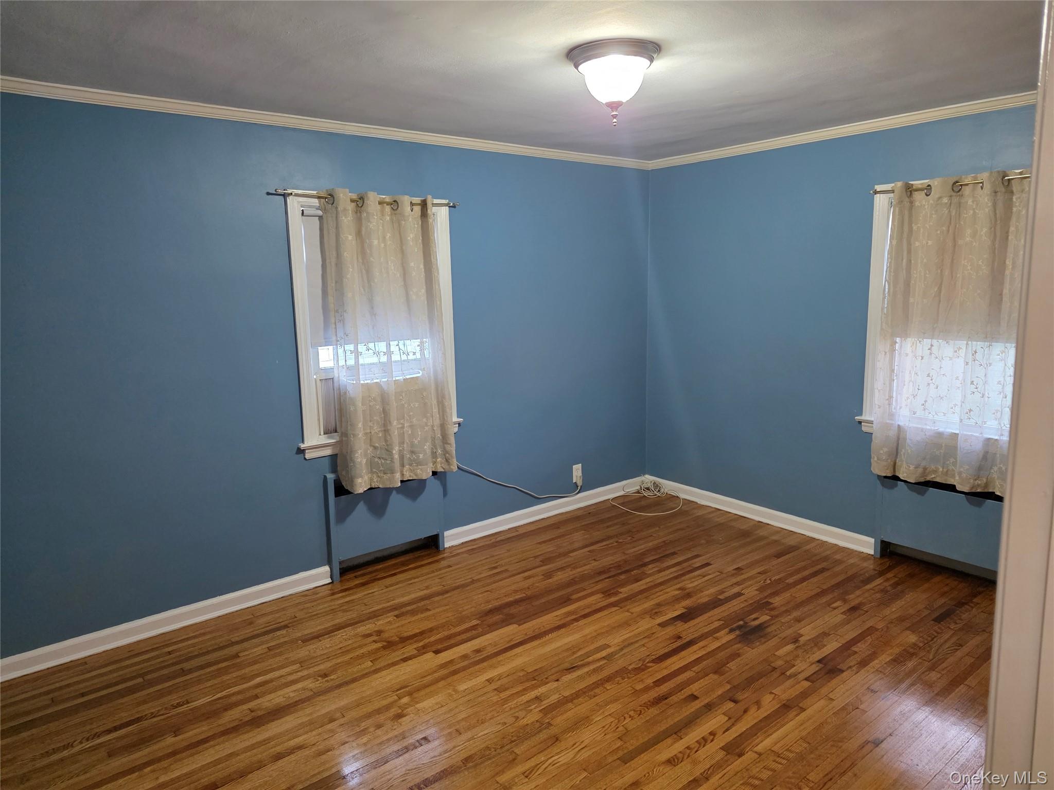 220 Raff Avenue Mineola, NY 11501 - Photo 11 of 22 Bedroom molding and dark wood finished floors