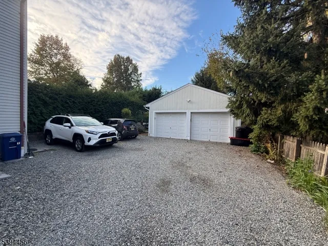 a view of a car parked in back yard of a house