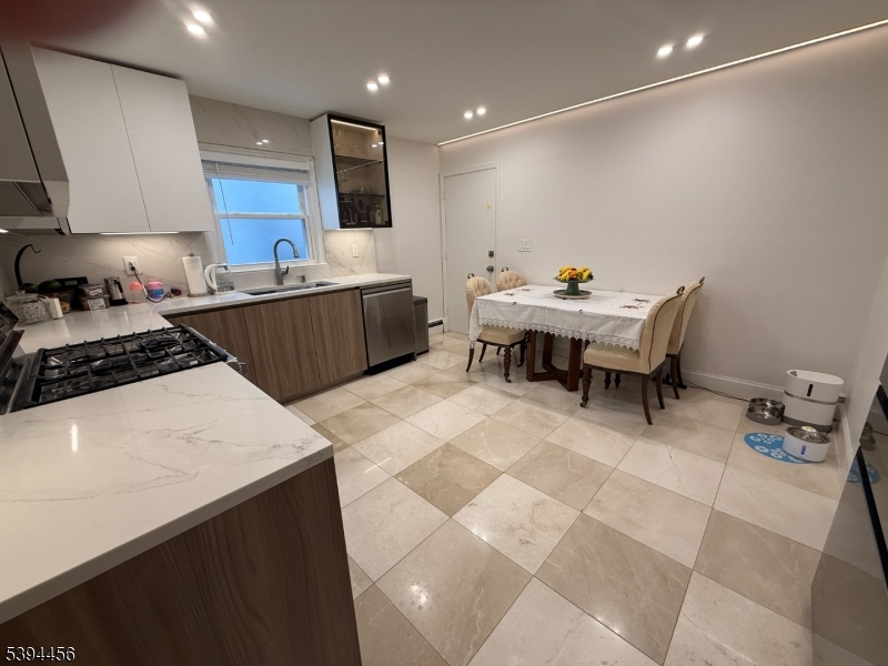 18 Aubrey Street Summit, NJ 07901 - Photo 4 of 20 a kitchen with a sink a counter top space and stainless steel appliances